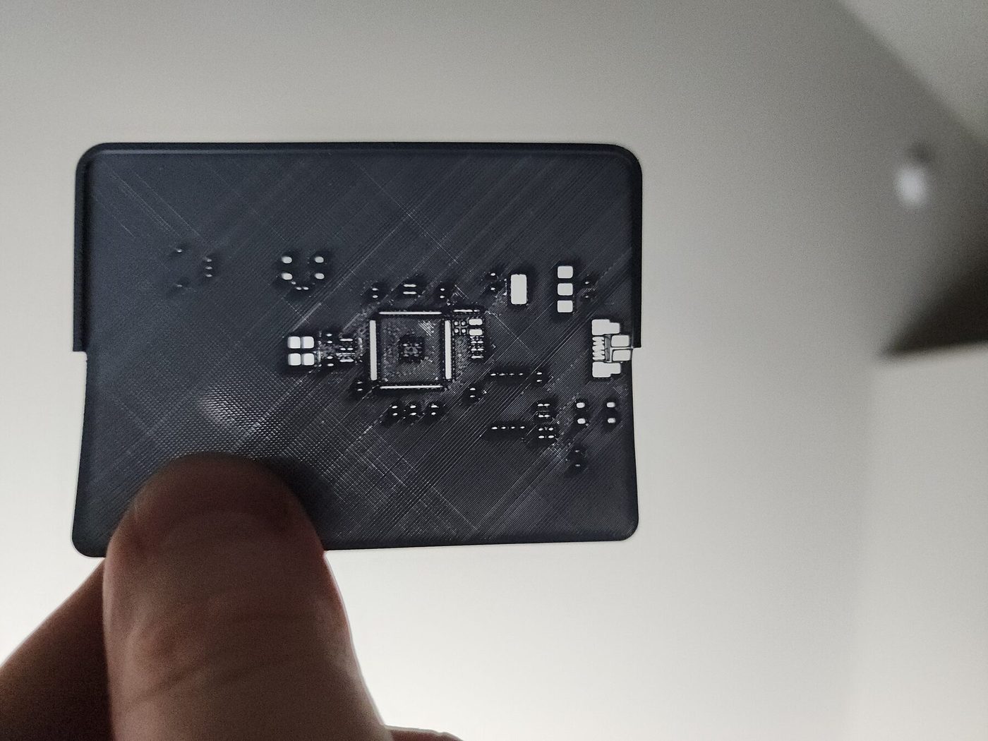 Grey solder stencil held up to the light
